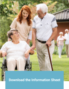 older woman in wheelchair smiles at older man while a nurse looks on