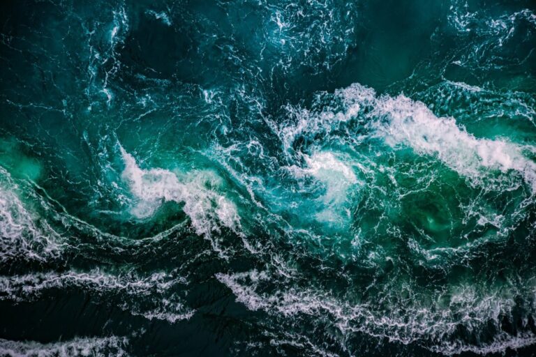 Birds eye view of the ocean with visible waves
