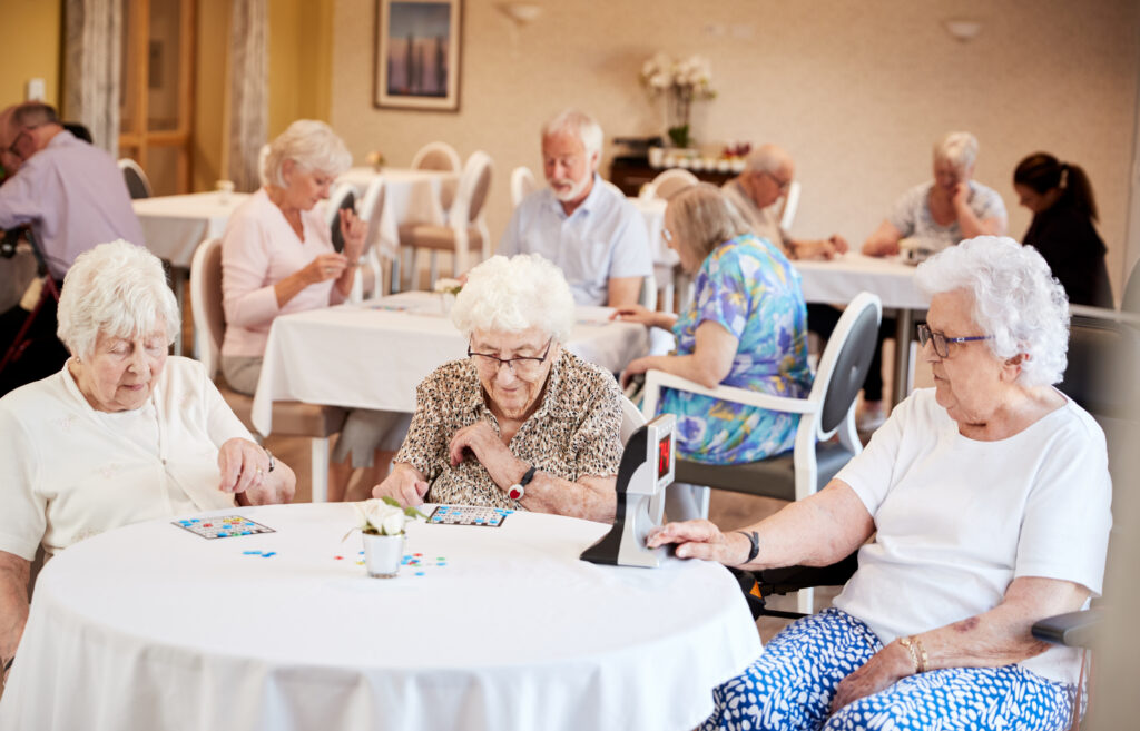Groups of residents at a senior living facility playing bingo