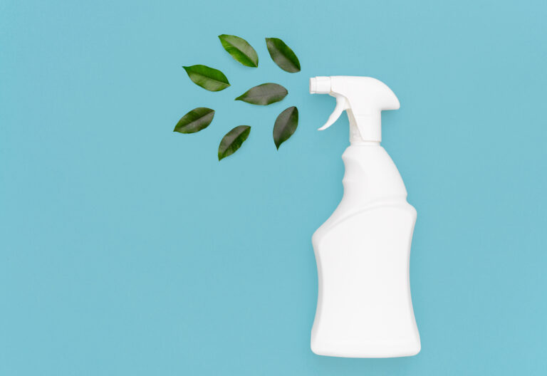 Generic white spray bottle with green leaves to resemble a sustainable and green cleaning solution