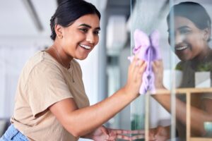 Hispanic woman cleaning a glass surface with Viking Pure Cleaning Solution